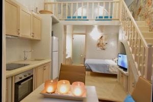 a kitchen with a table with candles and a staircase at Kathara Bay Apartments in Faliraki