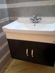 a bathroom sink with a faucet on top of it at Sinai Homestay in Alleppey