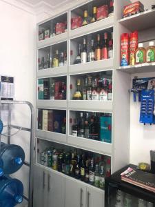 a shelf filled with lots of bottles of alcohol at Indesign Makumbi park studio Apartment D4-5,Syokimau in Syokimau