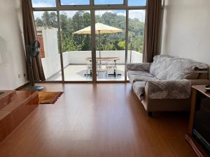 a living room with a couch and a table at THE MILKY WAY @ PINE RESORT in Bukit Fraser