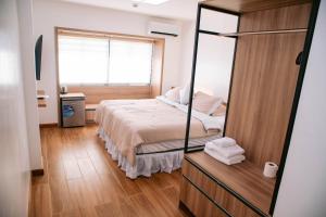 een slaapkamer met een bed en een grote spiegel bij Dream Residences in Manolo Fortich