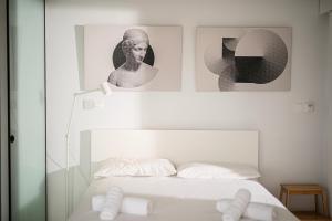 a bedroom with a bed with two pictures on the wall at Sky-view Hideaway in Nicosia