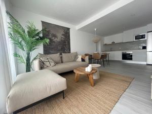 a living room with a couch and a table at Guiri Casilla de Costa Villaverde in Villaverde
