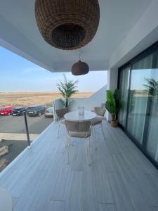 a dining room with a table and chairs on a balcony at Guiri Casilla de Costa Villaverde in Villaverde