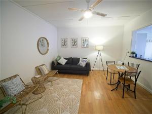 a living room with a couch and a table and chairs at Sea Salt at Stansbury Apartment 1 in Stansbury