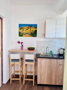 a kitchen with a sink and a counter at Ofim Holidays in Ambohidratrimo