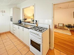 a kitchen with a white stove and a sink at Sea Salt at Stansbury Apartment 2 in Stansbury +9 photos