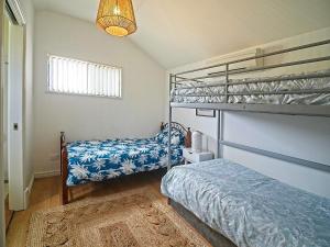 a bedroom with two bunk beds and a rug at Sea Salt at Stansbury Apartment 3 in Stansbury