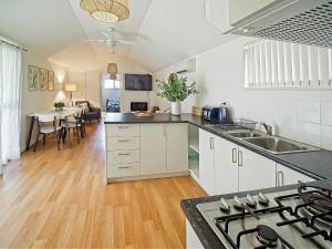 a kitchen with white cabinets and a counter top at Sea Salt at Stansbury Apartment 3 in Stansbury +11 photos
