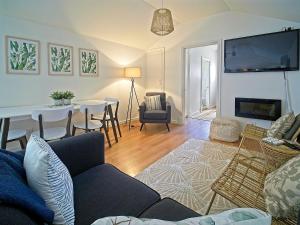 a living room with a couch and a dining room at Sea Salt at Stansbury Apartment 3 in Stansbury