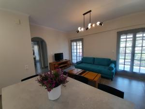 a living room with a blue couch and a table at Villa Emily in Syvota