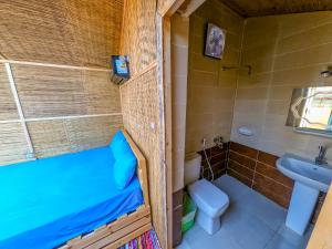 a small bathroom with a toilet and a sink at Baraka Camp in Taba