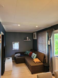 a living room with a couch and a window at Friends & Family Apartment at Hafjell Alpinlandsby/Øyer Center in Hafjell