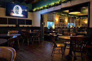 a restaurant with tables and chairs and a bar at The Corner Rooms at The Black Horse Inn in Spennymoor