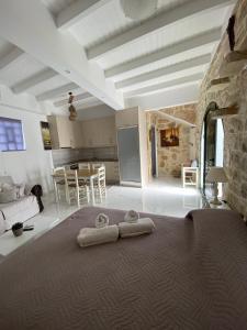 a bedroom with two towels on a bed at Lakoudia in Pitsidia