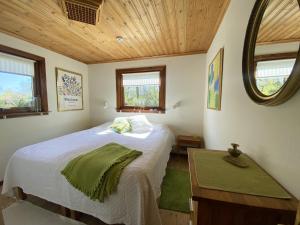 a small bedroom with a bed and a mirror at Holiday home within walking distance to sandy beach in Båstad