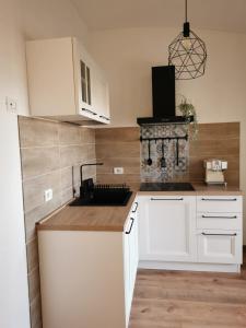 a kitchen with white cabinets and a sink at Maison Luna in Vasto