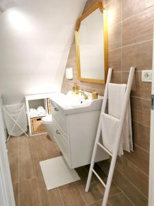 a bathroom with a sink and a mirror and a toilet at Maison Luna in Vasto