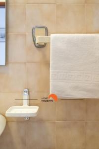 a bathroom with a towel rack and a sink at #132 Velamar 414 by Home Holidays in Caliços