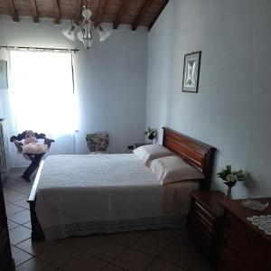 una camera con un grande letto e una finestra di Casa Zeno a Volterra