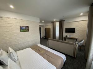 a hotel room with a bed and a television at Vatan Plaza in Tashkent