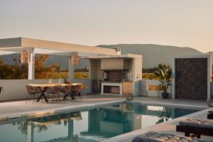 a house with a swimming pool with a table and a fireplace at Valley View Villa in Kalpaki
