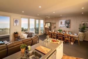 a kitchen and living room with a couch and a table at Sol Living Beach House in Brentwood