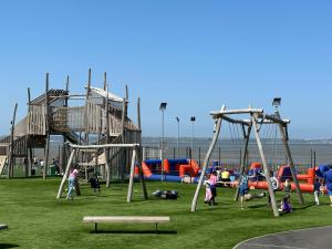 a group of children playing in a playground at 3 bedroom home on a Haven holiday park in Allhallows