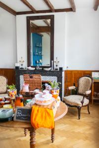 a living room with a table with food on it at Maison et table d'hôtes Le Camélia Blanc in Saint-Ciers-sur-Gironde