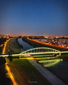 a bridge over a river with a city in the background at Villa Kap in Zagreb