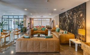 a living room with two couches and an elephant mural at Hotel Mainare Playa in Fuengirola