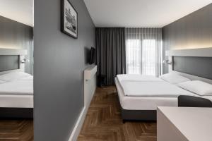 Postel nebo postele na pokoji v ubytování Hotel AMANO Rooms & Apartments + 37 fotografií