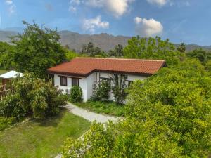 a small white house with a red roof at Akdeniz Bahçesi Apart Hotel by Kimera Lounge in Cıralı