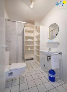a bathroom with a toilet sink and a shower at Ferienappartements Am Neuensiener See Ferienwohnung 2 in Sellin