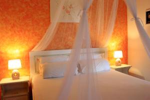 a bedroom with a white bed with a canopy at Tonias Houses - Thea House and Vrachos Attic Appartment in Alikanas +43 photos