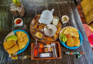 a table with two plates of food and a teapot at Mgoza Lodge in Cape Maclear +28 photos