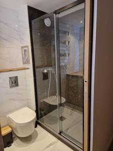 een badkamer met een toilet en een glazen douche bij Le Bellevue - Agréable Studio bord mer in Sète