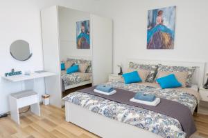 a bedroom with a large bed with blue pillows at Apartment Pemper - Self check in and check out in Otočac