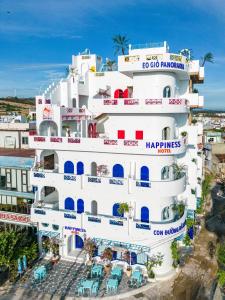 a large white building with blue and red accents at Happiness Hotel in Quy Nhon