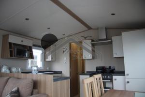 a kitchen with a couch and a table in a room at Tranquility - Static Caravan Lune Park on Parkdean Ocean Edge Resort in Heysham