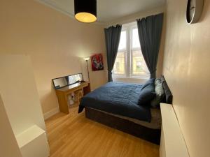 a small bedroom with a bed and a window at Paisley Pad: Glasgow Gateway in Paisley