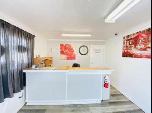 a room with a counter and a clock on a wall at Shannon Motel in Fort Nelson