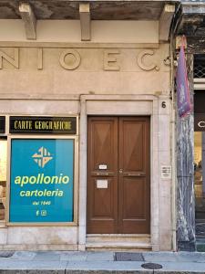 a building with a door and a sign on it at Eleganti Dimore in Brescia