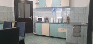 a kitchen with a counter with a microwave on it at Pensiunea Cezar-Codrin in Cheia