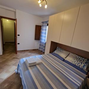a bedroom with a large bed in a room at Ambrosia casa vacanza " Giada " in Orosei