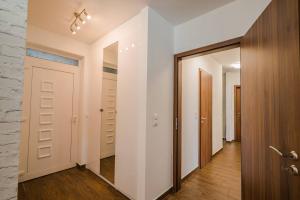 a walk in closet with white walls and a door at Luxus Partivilla Apartman in Szántód