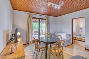 a dining room with a table and chairs and a bedroom at Lovely House Near Zagreb With Terrace - Happy Rentals in Graberje Ivanićko +17 photos