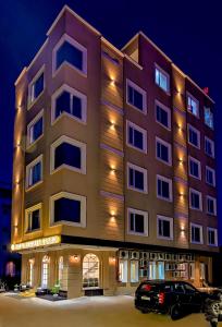 a building with a car parked in front of it at Regalia Grand By Delight Stay in Amritsar
