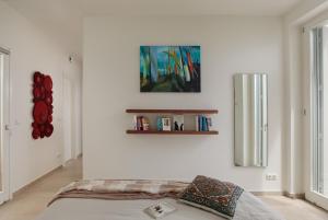 a bedroom with a bed and a painting on the wall at Villa Almiriki, Stelida Naxos. in Naxos Chora