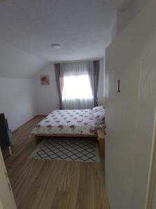 a small bedroom with a bed and a window at Nice view-Plitvice in Korenica